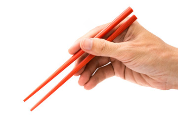 hand holding red chopsticks isolated on white