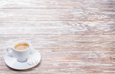 white cup espresso on light wooden background
