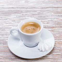 white cup espresso on light wooden background