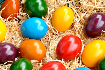 Fototapeta na wymiar Colorful of Eggs for Easter time. a lot of colorful eggs on Artificial straw.