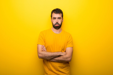Fototapeta premium Man on isolated vibrant yellow color with sad and depressed expression