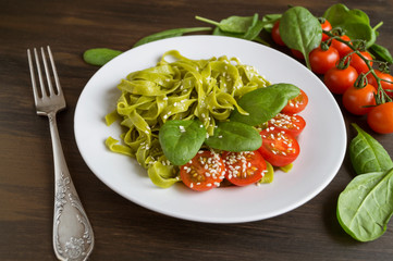 A set of ingredients for Italian pasta. Black background with free space for text. Pasta, tomatoes, fresh ground beef, garlic, carrots, onions, celery on a rustic Board. the view from the top