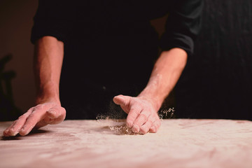 Obraz na płótnie Canvas hands kneading dough on table