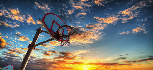 Basketball hoop under a colorful sky in Laguna Beach