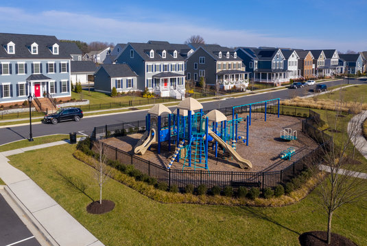 Aerial view of typical american colonial single family luxury home real estate with playground for upper middle class families in the USA