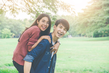 Portrait of asian couple in love smile and feeling happy. Lover having a good time and embracing in the park