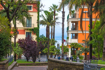 Fototapeta na wymiar Palm trees and elegant buildings in Sorrento shore