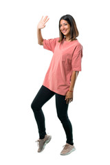 Full body of  Young girl with pink shirt smiling and saluting