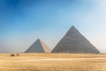 Amazing view of the pyramids of Giza in a blue sky day