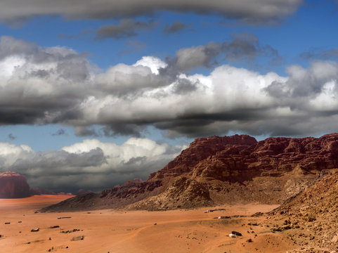 Aerial photograph of a dark dramatic sky with many clouds over the desert Wadi Rum in Jordan, combined image, taken with the drone