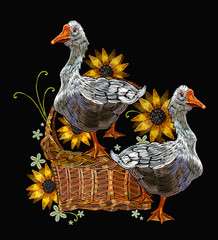 Embroidery two geese in a wicker basket with sunflowers. Template for clothes, textiles and t-shirt design