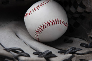 old used baseball glove and ball isolated closeup