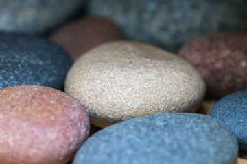 Fototapeta na wymiar multicolored decorative stones, close up, blurry background