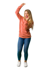 A full-length shot of a Young girl celebrating a victory on isolated white background
