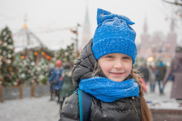 child at the Christmas tree in the square
