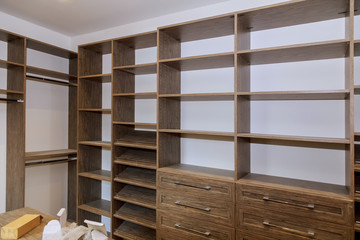 Large with in closet with many shelves and drawers.