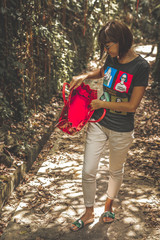 Woman with luxury snakeskin python handbag in the tropical forest. Bali island.