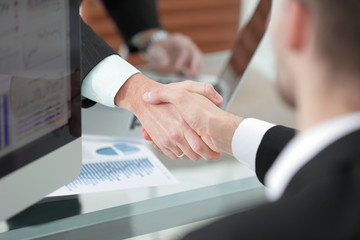 close up. handshake of business partners above the Desk.