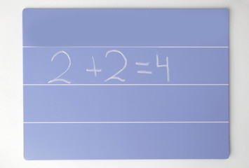 close up. the formula is written for the children's Board on a white background