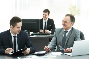 business colleagues sitting at a Desk in the office.