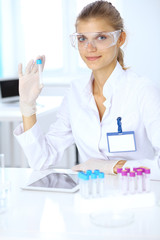 Fototapeta premium Female scientific researcher or blood test assistant in laboratory. Medicine concept