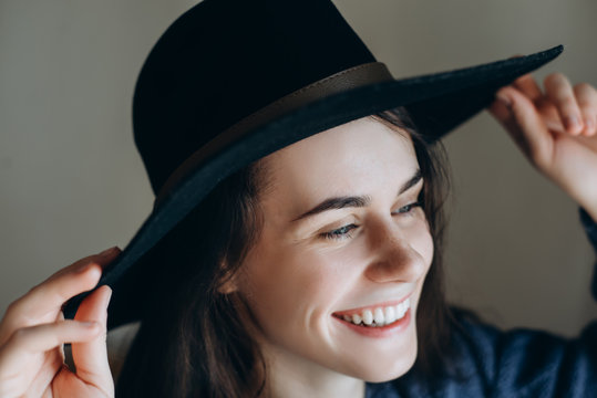 Portrait of beautiful young happy woman wearing  black hat .