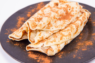 Pancakes stuffed with braised apples sprinkled with cinnamon