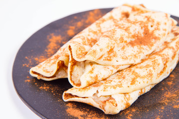 Pancakes stuffed with braised apples sprinkled with cinnamon
