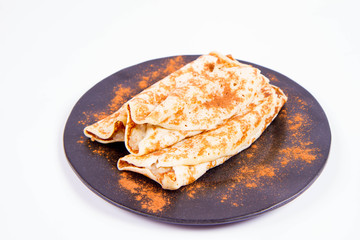 Pancakes stuffed with braised apples sprinkled with cinnamon