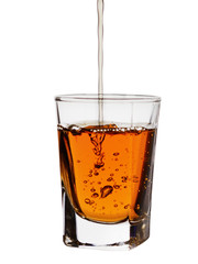 aged in barrel for several years, alcohol is poured into a small glass beaker, isolated on white background