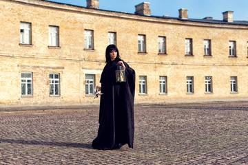Young girl in a long black coat