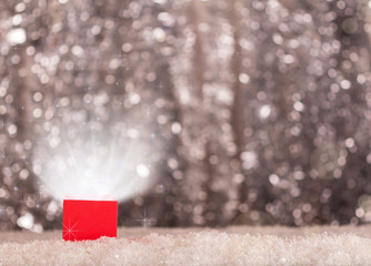Magic box is magic in the snow on bright background with bokeh effect