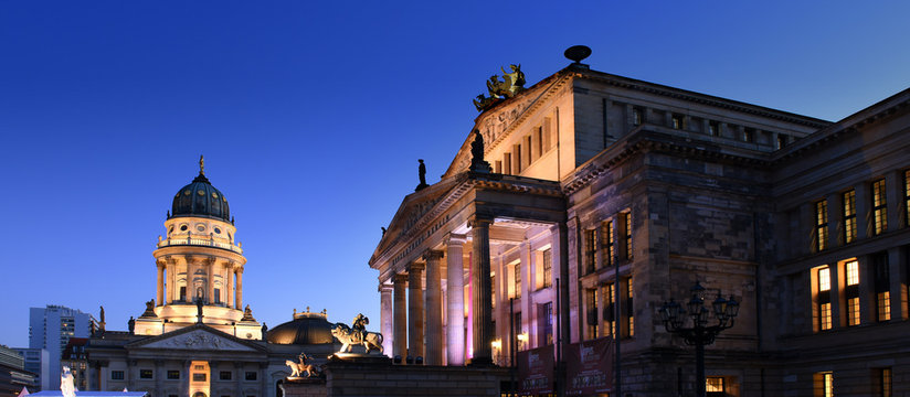 Konzerthaus Berlin with lion statue on Gendarmenmarkt square at night with German cathedral in the background, Berlin City, Germany
