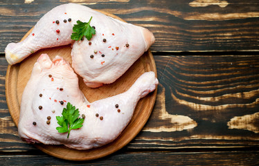 chicken legs on wooden background