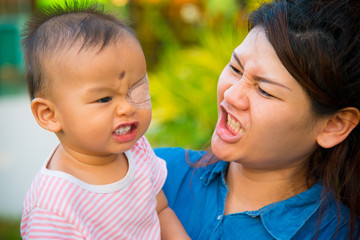 Asian female model and asian baby pose for pictures in the nature