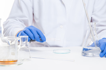 view of a human hands in the laboratory while performing experiments