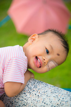 Asian baby poses for pictures in the nature