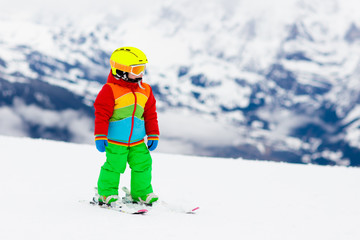 Fototapeta na wymiar Kids ski. Winter family snow sport. Child skiing