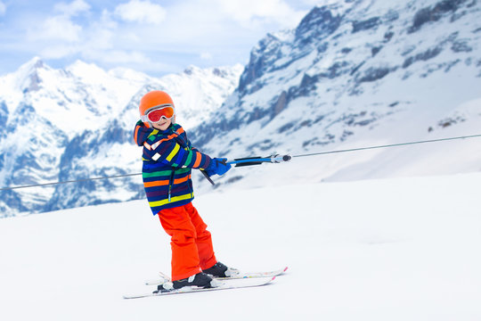 Child on ski lift. Kids skiing.