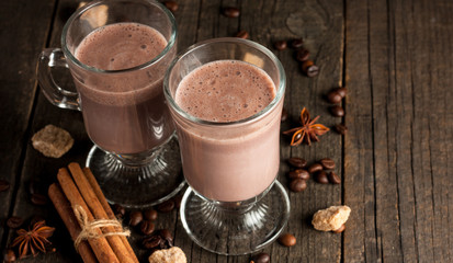 Chocolate, coffee, milk, banana shake on wooden background. Smoothie with cookies. Milkshake. Protein diet. Healthy food concept.