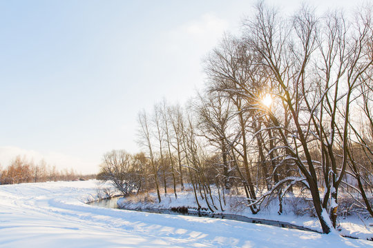 Fototapeta Beautiful winter landscape. River in snowy forest