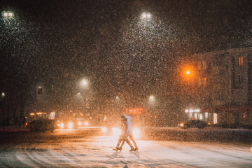 man walking in the street at night in winter