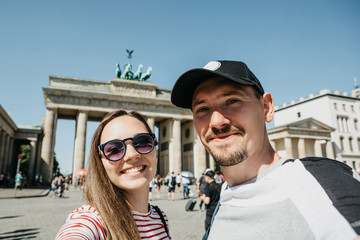 Young beautiful couple making selfie against the background of the Brandenburg Gate in Berlin in Germany. © franz12