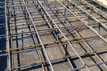 Tie rebar beam cage on construction site. Steel reinforcing bar for reinforced concrete.