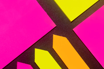 Yellow, orange and purple hue colorful office stickers on black paper. Office noteparer as...