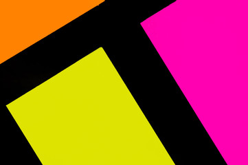 Yellow, orange and purple hue colorful office stickers on black paper. Office noteparer as...
