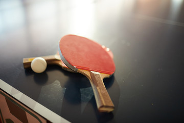 Table tennis rackets and ball for two players of ping pong in contemporary sports center or hall