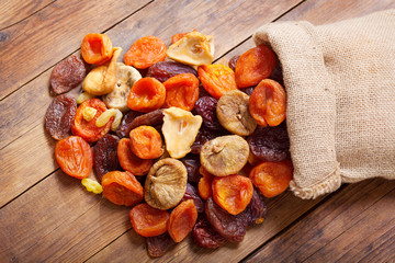 mix of dried fruits on wooden table