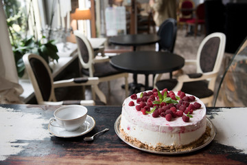 Vintage cafe, on the old steel cake with berries, a cup of tea