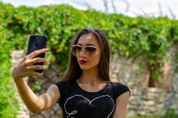 young woman in the park making selfie